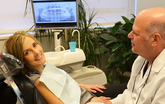 a happy patient who works close by is getting dental treatment by 209 NYC Dentist