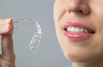 Someone examining clear aligners