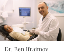 A cosmetic dentist helping a patient