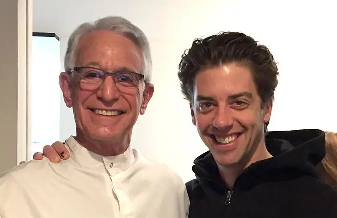 A dentist smiling with a patient